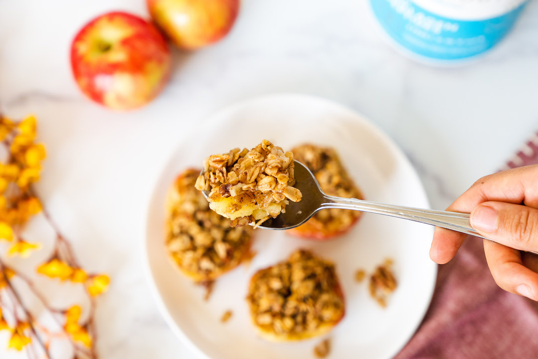 A spoonful of healthy baked Cinnamon Apples with oat crumble and Super Youth Collagen peptides