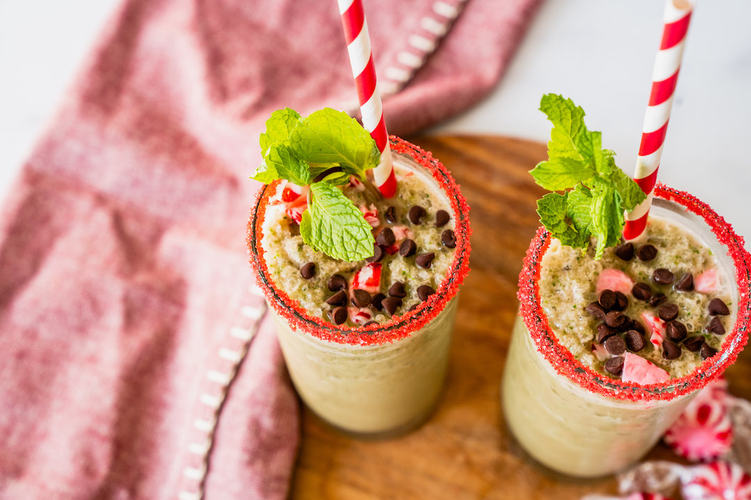 Mint Chocolate Shake with Super Youth collagen served in two glasses with chocolate chips and mint for garnishes.