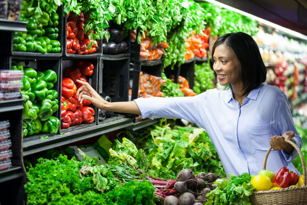 A woman picking vegetables for a meal. Eating veggies is one of the top healthy holiday tips from Super Youth.