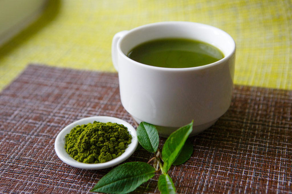 Cup of warm green tea, one of the best superfoods for weight loss along with Super Youth Skinny Greens.